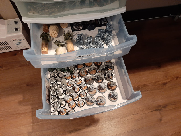 The plastic bin drawers are lined with some heavy paper towels to keep everything for sliding around.  They can be removed and set on the work bench so you can move your whole army/project at one time instead of individual pieces.