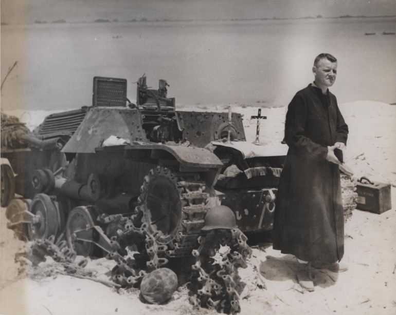 1944 Saipan. Priest says Mass on a ruined tank