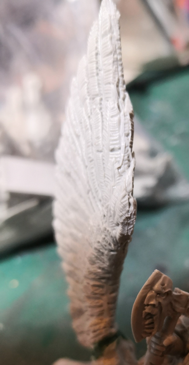 On the wing of the war boss's bull mount the most prominent feather near the dwarf's head had near no detail due to being an attachment point of the scaffoling. I had to try and carve it back in. I think it'll do.