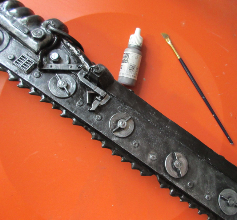 Everything gets a light drybrushing with natural steel. This makes the sword look metalic.