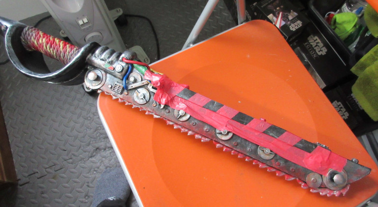 I masked off the area to be left black with masking tape [Use decent quality stuff - the cheaper brands either won't stick so paint leaks under it, or will lift off the base paint when being removed].