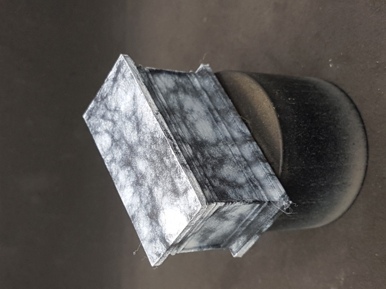 I then sprayed the covered pedestal with light grey and dried it with a hair dryer. Then the cloth was removed leaving a kind of marble finish.