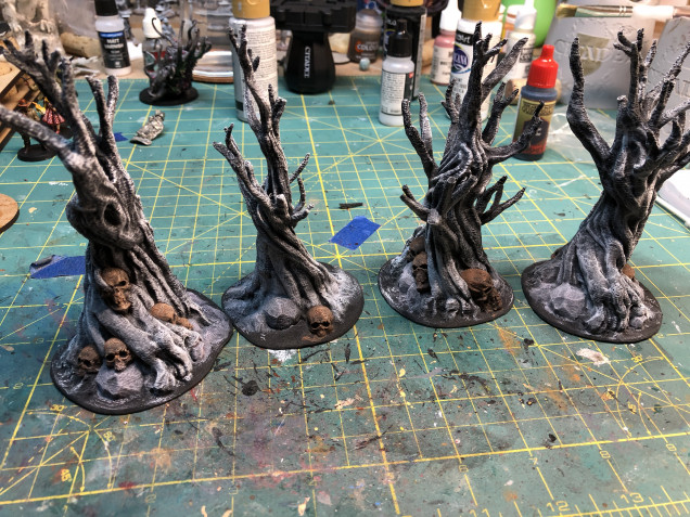 3D Printed and primed black. before dry brushing off white paint and applying beige drybrush to the skulls