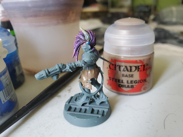 As @portcullis said, the uniforms tended to be a drab khaki that was dyed green for the jungle, so I started with Steel Legion Drab.