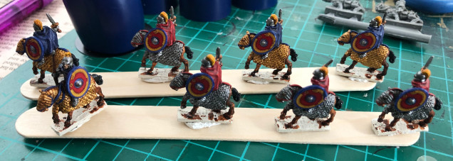 Layers added on details, (base layer, with lighter shades of base layer on top for details, but with skull crusher brass as final layer for gold armour). Also added shields.  