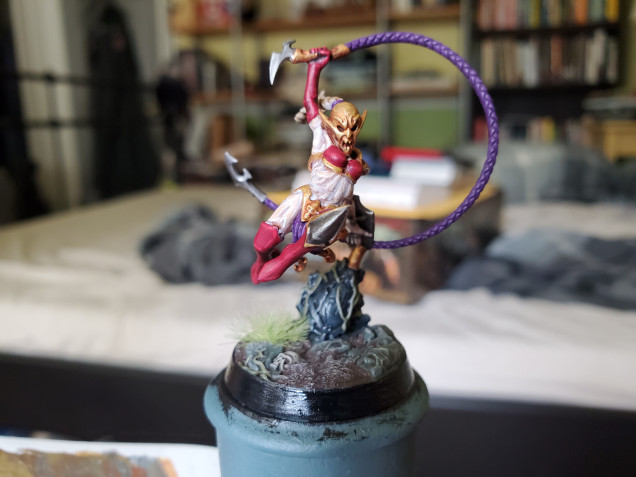 I chose my own colours, based upon a previous mini that I painted many years ago, going with red and purple. The purple isn't as obvious here, as Khamyss (I looked up her name) seems content to wear only three strands of cloth from her knickers rather than the usual loin cloth...