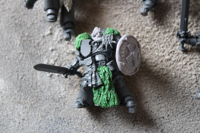 The head in this instance is a Forgeworld one but I also used some heads from Spellcrow which work perfectly. The green stuff is all covering the cloth and them I prodded my hobby knife in ALOT and it creates a simple fur. The shield is the Forgeworld one