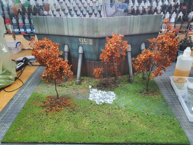 I then glued everything down the tree roots were done with superglue after pinning the trees then sprayed the same brown as the trees. I flocked the whole board and used a watered down PVA mixture. Sadly, again the patch gave me issues and I had to do this in sections removing the unwanted flock over the stones with a damp brush. 