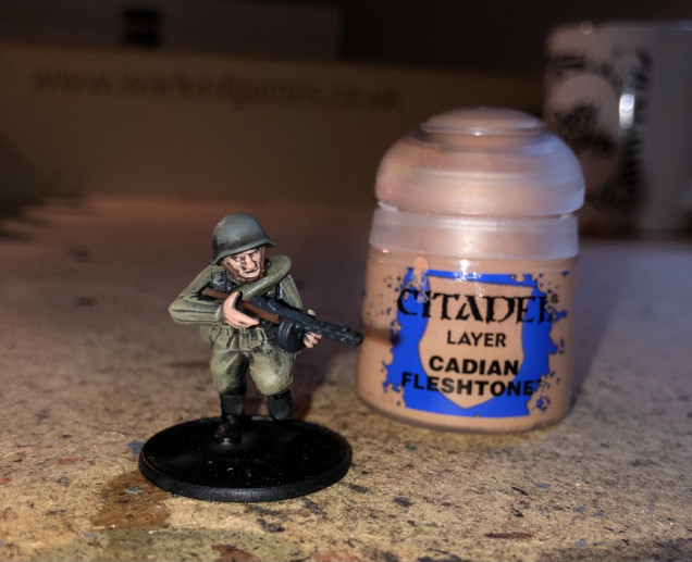 Step 9: For the final step I highlight the flesh with Cadian Fleshtone. 