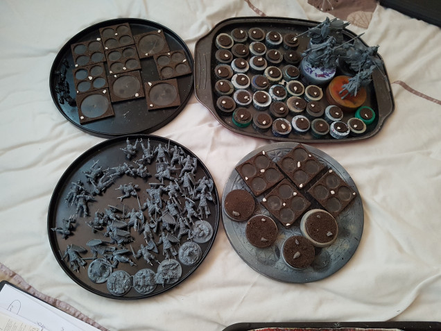 All the 100 Kingdoms models from the 2 player starter set, all built and ready to rpime.  All the bases are prepared, with their sealant coat of PVA currently drying.  They'll be ready to prime in a day.