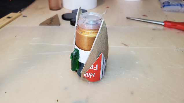 I cutout the profiles and formed them around the paint pot tower. Secure the profiles to the base of the paint pots with hot glue. This should allow the profiles to flare off a bit from the unit to create some volume. I layered on some additional card to breakup the panel surface.