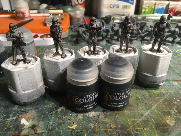 Use two contrast paints, grey on armour, black on gun, black undersuit and eyebrow