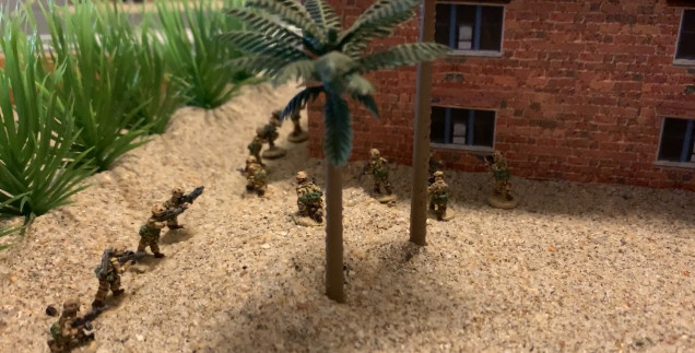 Marine squad under cover, tentatively probes forward to find the enemy