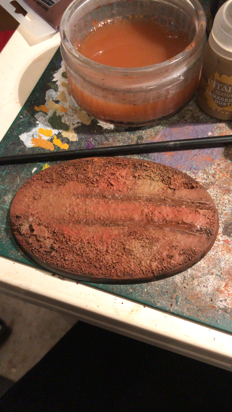 The base was covered in miliput and the mules wheels were rolled in it to create track marks.Sand and gravel was then added. The base was painted with a mix of Martin iron earth, brown acrylic and jungle earth weathering powders.