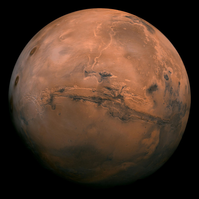 The Red Planet...that is actually sort of brown-ish. The massive scar you can see here is an ancient canyon called Valles Marineris that shows signs of once carrying water across the surface.