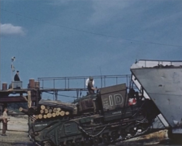 An AVRE of 80 Asslt Sqn RE being loaded up on the 2nd June, the Log carpet is clearly visible and also you can see variation in the original design, as there are far less logs than intended.