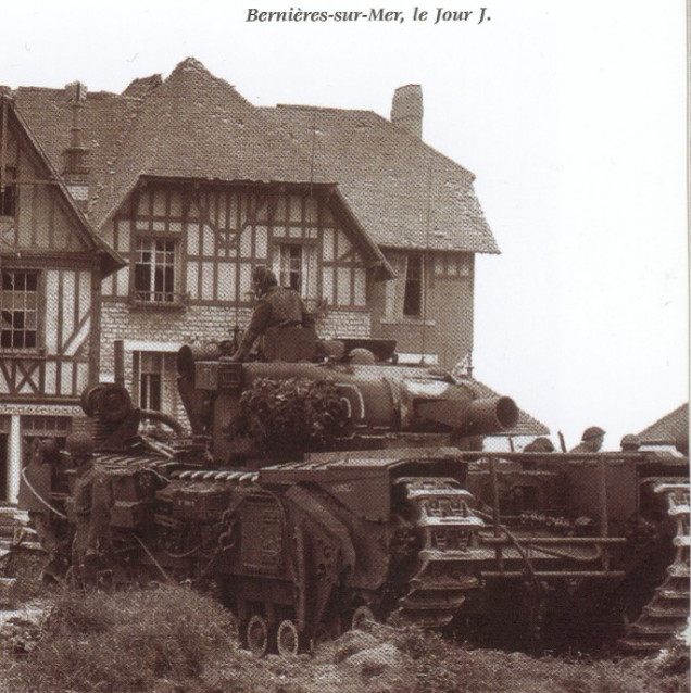 I believe this may be the same AVRE on D Day (Juno Beach supporting 3rd Canadian Inf Div) parked up on the outskirts of St Aubin-Sur-Mer. You can make out the timber bed on the track cowls and also the drop arm made of tubing, swung down in front between the two sets of tracks. It is also interesting to note that the positions of the cross bars is such that, when down, it does not impede the use of the bow machinegun.