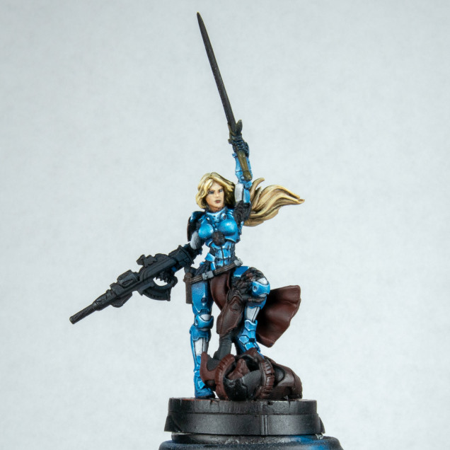 I love the hair on this model I had to paint it. Normally I would have left the gun hair and sword until the end. The main reason for this is that I have a tenancy to rest my hand on the model and can rub paint off or add hand oils. However her hair seems to be about 1/3 of the model and I wanted this very blond.. I started with English uniform flat colour. I then added some gold brown. When applying this I do small strokes almost little lines  in the direction of the flow of hair to build up the texture. As I took this so light most of it was lost but it pleasures me to know it's under other small lines. At the stage of the gold brown I then washed with sepia ink in places and adding a little black in as well. I then re applied the gold brown and then added ice yellow to consecutive layers ending with ice yellow and white for the last very top highlights