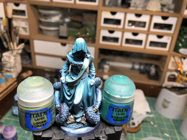 In order to create a subtle contrast on the dress and sash without destroying the airbrush highlights, I applied two diluted glazes of green, one GW Loren FOrest to the sash and one GW Kabalite Green to the dress. Make sure the effect is subtle and do not let it pool in the crevices.