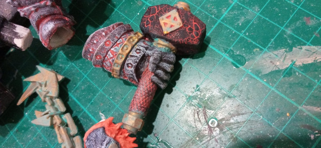 I wanted to simulate a kind of heat cracking stone effect so I put a layer of mordant earth over the Red Hammer