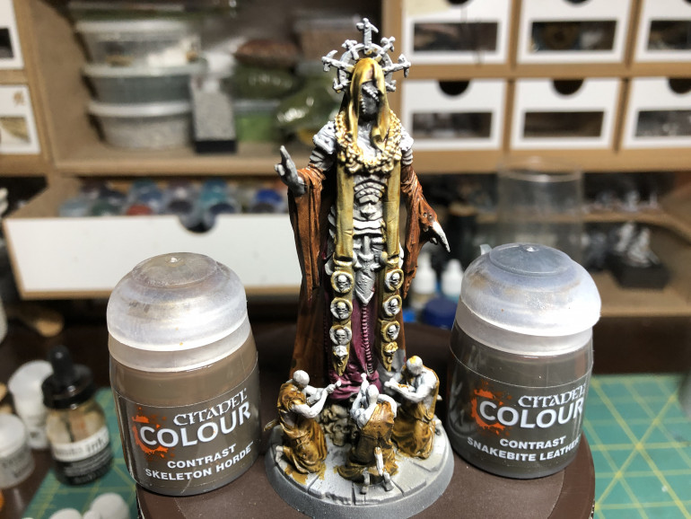 Base skulls were given a layer of GW Contrast Skeleton Horde and the minion robes and mask were painted GW Contrast Snakebite Leather.