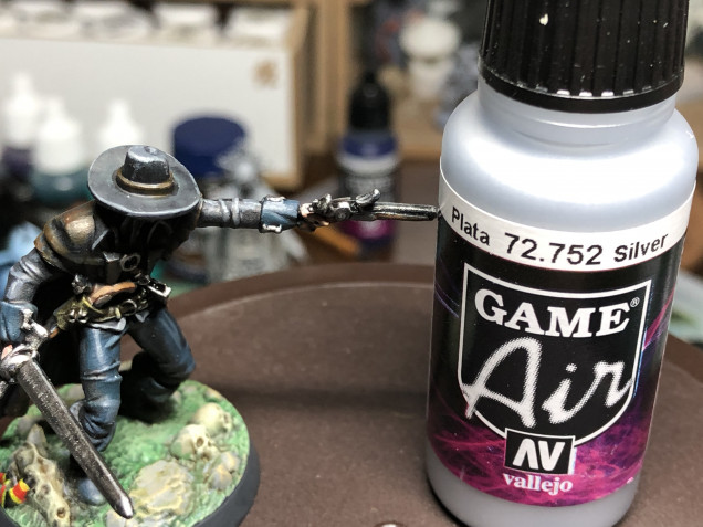 Metallic parts (pistols/buckles/sword) were given a layer of Leadbelcher and a wash of Nuln Oil Gloss. They are then  highlighted with Vallejo Air Silver. Ensure to only highlight teh pats hit by the zenithal light.