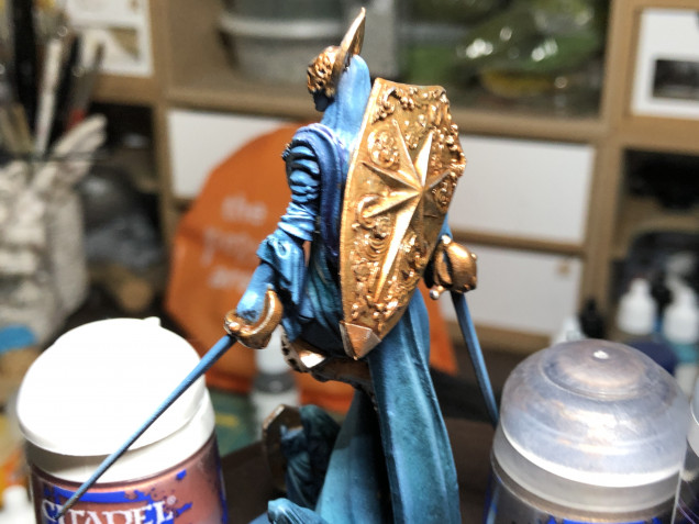 Brass silver highlights are reserved for the areas of the metal most hit by zenithal light. I also highlighted the hair with pure white in the most exposed areas, along with edge highlighting the upper swords' edge with white.