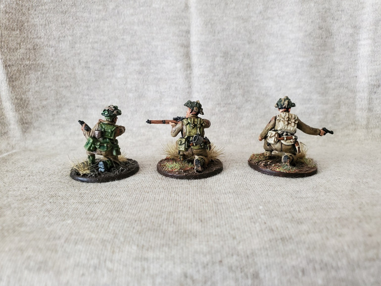 So here's where I started. On the left is a Sergeant that I painted the webbing on recently to my 'new standard', in the middle is a Sniper that I experimented on a while back with some Athonian Camoshade, and on the right is a Spotter with the original beige colour I painted.