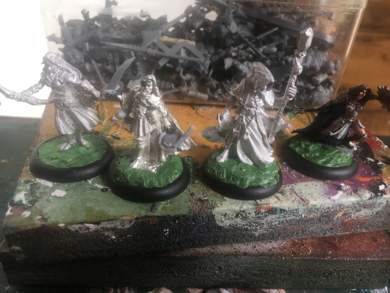 From left to right: Glow, Captain Flameheart, Alvoril and Amber the Cleric. All Reaper Miniatures mounted on 30mm lipped round bases with green stuff used to fill the gaps. Undercoating with Citadel Chaos Black.