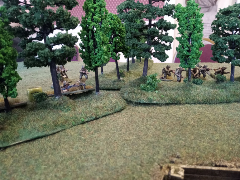 Easy Company advances behind the tree line