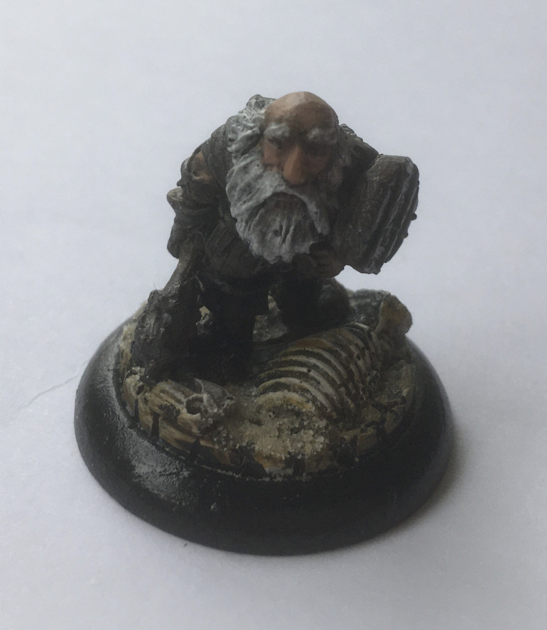 The Dwarf Cleric - Model chosen Citadel Miniatures (May 1985) CO6 Dwarfs Tribesman sculpted by the Perry Twins. Mounted on a 30mm lipped Micro Arts Troglodyte base. A real oldie here, who’s expression reminds me of the stoical characters that I like to play and RPGs have taught me about the value of stoicism. With his plate armour and adventurer’s backpack, he’s a suitable foil to the keener Grail Knight. 