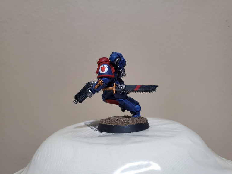 I also added a red strip to the casing on his chainsword just to add a little more personal flare, though this I'm keeping with the Sergeant. I did think of adding the white stripe of a Veteran Sergeant, but I'm saving that for rewards if the squad does well in a game...because I will be able to play games again eventually...right?