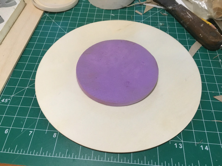 I used a hot glue gun to attach a foam circle to the wooden one.
