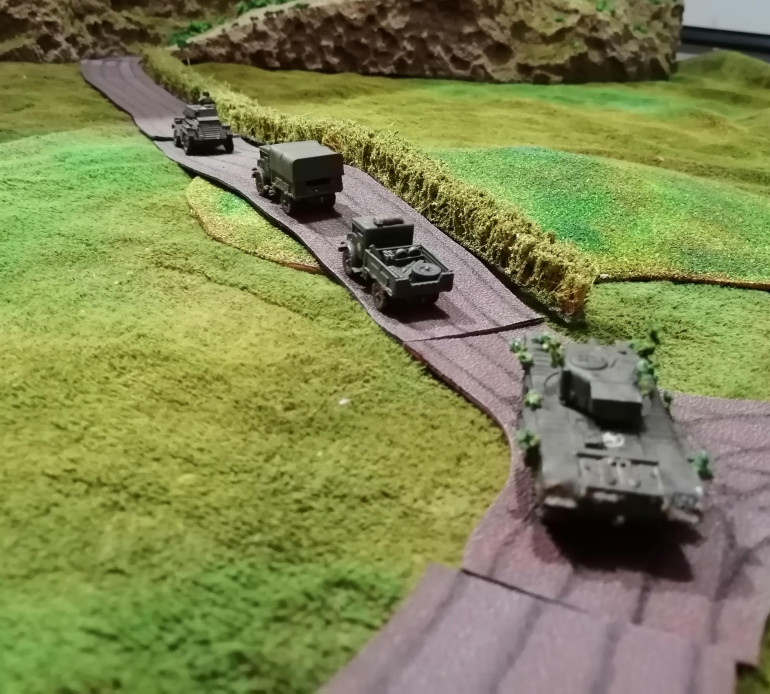 A Churchill from the North Irish Horse escorting a couple of supply trucks