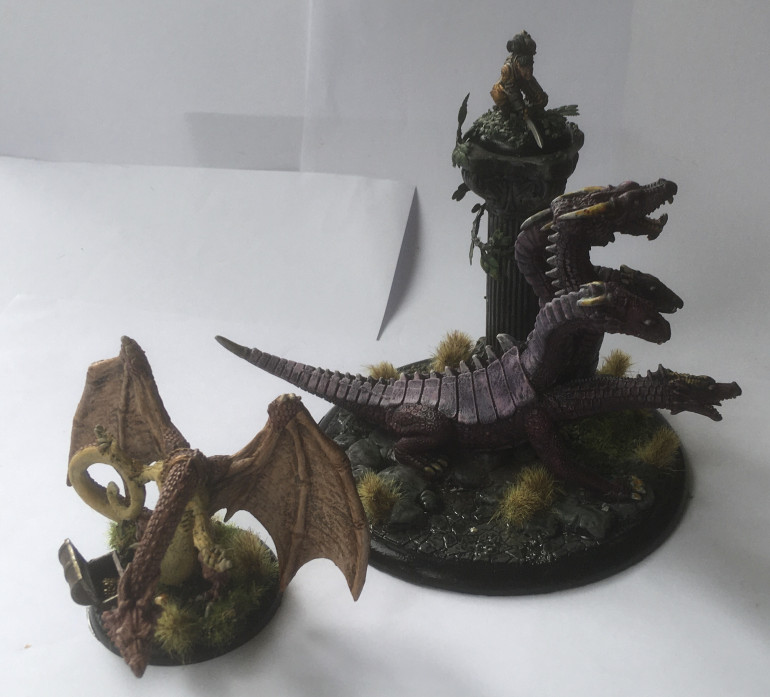 Size comparison of Shire Dragon and Spectral Dragon II from Grenadier Miniatures, including Reaper Miniatures ‘Gavin’ on the column in the background.