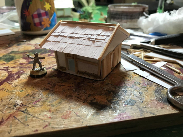 The last step is to cover the plain walls and roof in strips of paper, hopefully this will give a nice natural material effect once painted.