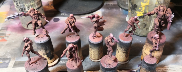 Some minis airbrushed with a red leather undercoat with orange leather highlights.