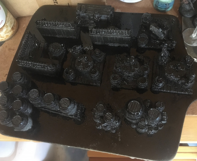 After washing the resin pieces in warm, soapy water and left to dry, the furniture was undercoated with black spray paint. 