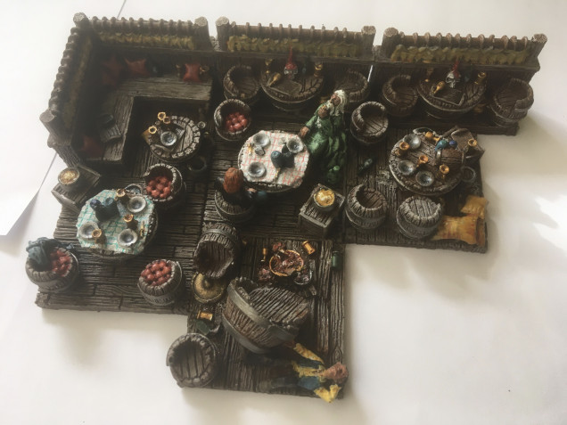 After a bit of a slow couple of weeks due to work commitments, I’ve managed to get the fine detailing done on the Grendel Miniatures tavern scenery. In essence, I’ve used plain, primary colours using a foundation and wash to get the effect that I’m looking for… I need the scenery to look good, but to not detract from the Dunkeldorf Miniatures for Phase 3 of this mini project within the project. Citadel Paints used: Abaddon Black, Nuln Oil, Macgrabbe Blue, Drakenhof Nightshade, Lothern Blue, Leadbelcher, Averland Sunset, Carriburg Crimson, Retributor Armour, Mephiston Red, Blazing Orange, Reikland Fleshshade, Cadian Fleshtone, Agrax Earthshade, Dark Angels Green, Thraka Green, white Scar, Wraithbone.