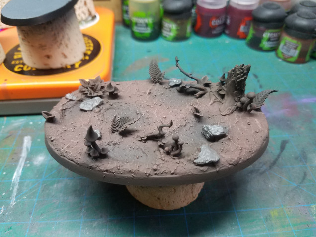 Drybrush the ground gorthor brown(gw) and base coat the rocks stormvermin fur(gw)