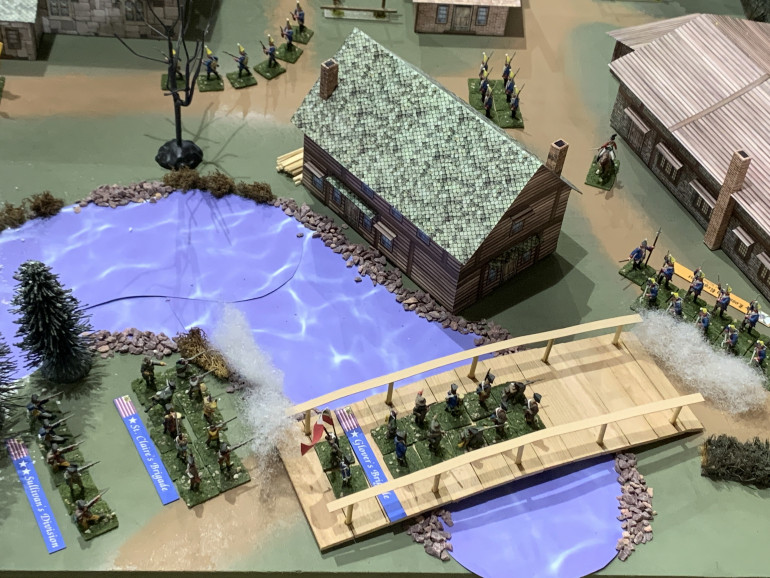 Sullivan's Division - including Glover's Brigade, St.Claire's Brigade, Sergeant's Brigade (off table), cross Petty's Creek behind the Pott House (Rall's HQ) and engages the Hessians as they try to form up out of the stone barracks.