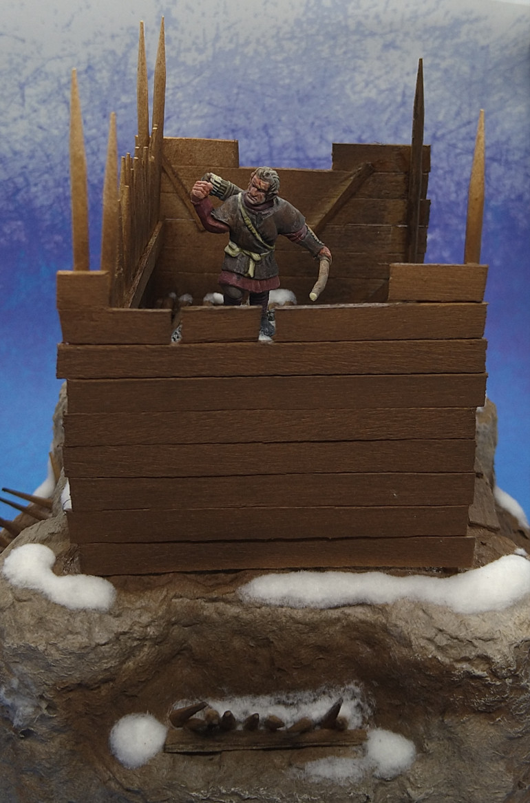 Lookout post made from cocktail sticks, coffee stirrers and snow flock. These rocky rises are all from one piece of packaging. I plan to have them at the corners of a mat, with some other stronghold like structures in the middle so that no one side gets full advantage of the cover and vantage they offer. The warbands have already breached the perimeter as it were. The loot being mostly in the middle I wonder what scared off the people that were willing to hack into permafrost and waste wood on defenses?