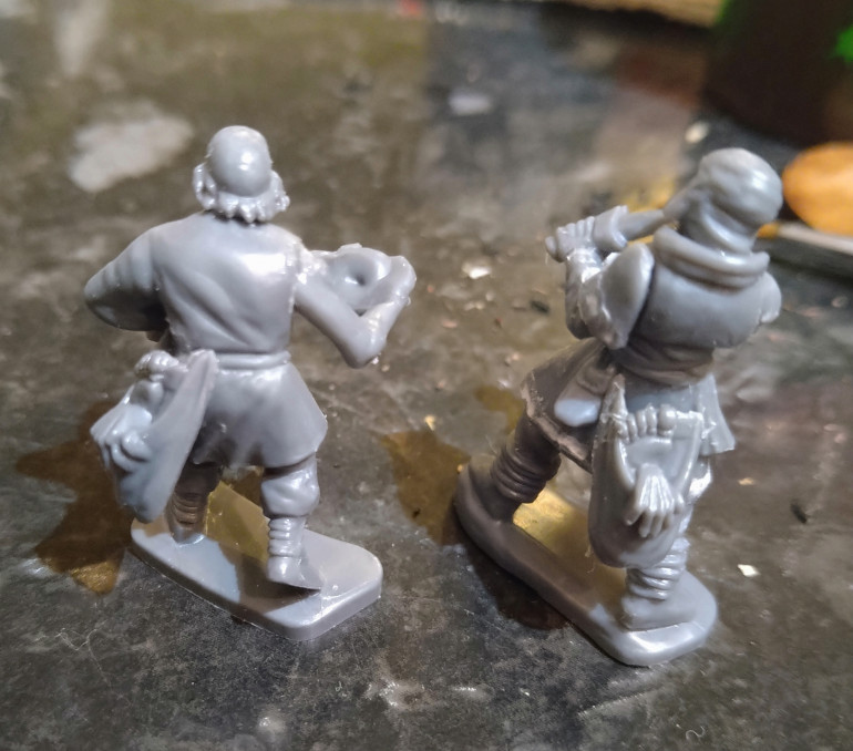 Right: Frostgrave Soldiers 2 body, head and left arm with Mantic Games zombie right arm and Mantic Ghoul snack bag.