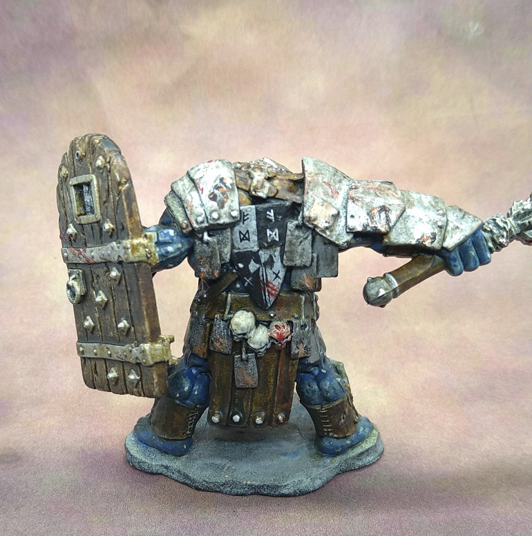 The shield on his back is part freehand for the axe and crosses and part transfer with the runes. The door shield is watered down Wyldwood Contrast Paint.