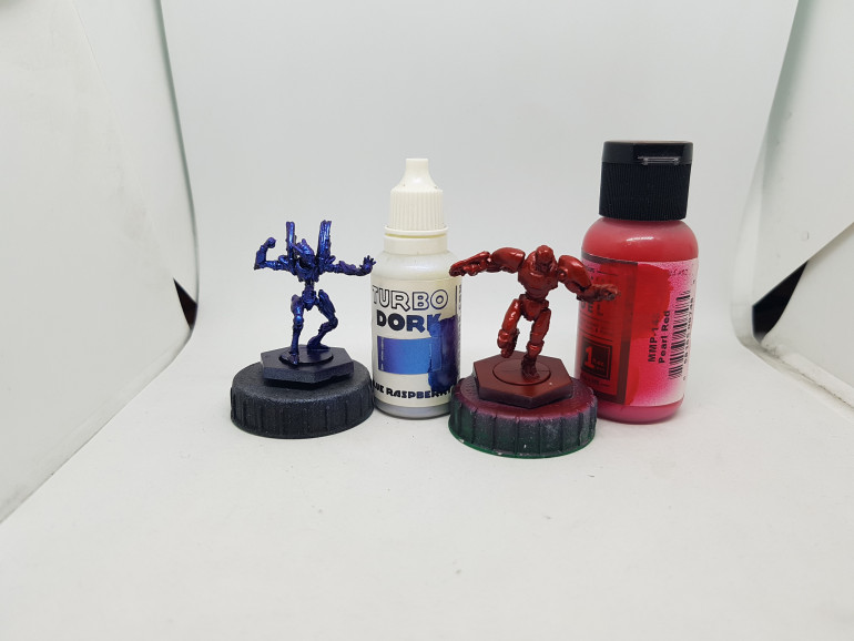 Colour Shift Turbo Dork Blue Raspberry for the asterian.  The Shiny Red Robot as undercoated with Steel and drybrushed with silver (Dunno if preshading matter here?) and then given a few coats of Mission models MMP-148 Pearl Red.  I Put one coat all over, then added more coats from the sides and then only from above