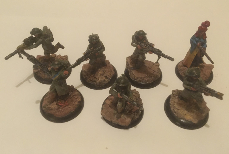 So here are the British Sniper Heroines now ready to go to battle. After a white spray undercoat I probably spent near on 6 hours painting these ladies up.  Tunics : Steel Legion Drab; wash of Thraka Green; highlight of Deathworld Forest; highlight of Wraithbone 1:1 Deathworld Forest. Buttons: Retributor Armour.  Weapons: Abaddon Black; Highlight Chainmail; Highlight Retributor Armour; Wash Badab Black.  Helmets: Orkhide Shadow; Wash Thraka Green; Wash Seraphim Sepia; chips Chainmail.   Bases: Wash Agrax Earthshade; Highlight Wraithbone; Wash Agrax Earthshade. Base lip: Abaddon Black; ‘ardcoat .  Blue Blouse: Lothern Blue; Wash Drakenhof Nightshade; highlight Lothern Blue 1:1 Wraithbone; Wash Drakenhof Nightshade.  Red hair: Mephiston Red; Wash Babdab Black. Skin: Cadian Fleshtone; Reikland Fleshshade .  Weathering: Vallejo Brown Iron Oxide; Vallejo Light Yellow Ochre