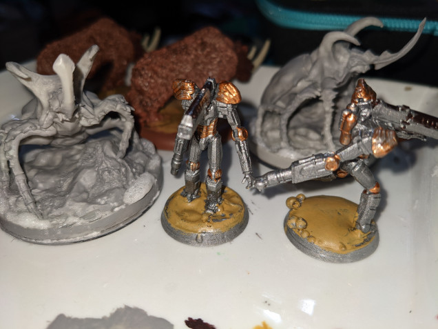 Not much today. Put some Primitive Lizardmen into slottabases, put some CA glue and baking soda onto the big insect base and did some basecoating of the Sentrabots. Slow, steady progress.