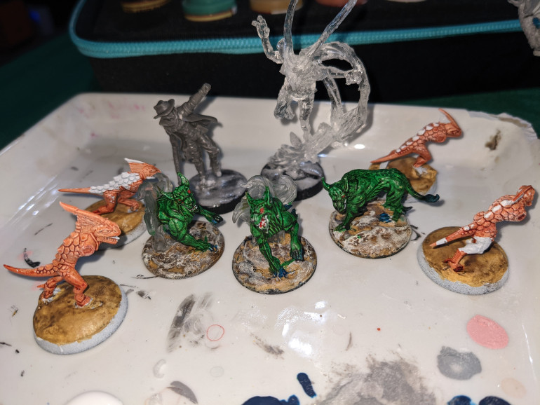 Eh, generally bleh about my warp hounds. A little detail work, but... The primitives I'm happier with; the white drybrush brought them back up again. Besides that, some basing work Eh, they can't all be gems. Better than no paint, if only barely.