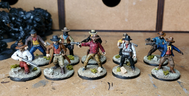 Two of the metal minis from the original two player set - front row centre and second from the right - for size comparison
