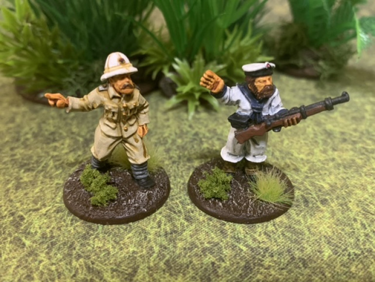 A German naval officer on the left in a white tropical hat and khaki landing party uniform while on the right, an enlisted sailor in the tropical landing party uniform with naval cap. Why the officer’s uniform was issued in khaki and the enlisted sailor’s uniform was issued in white boggles the mind. The white uniforms and hats were quickly dyed to a khaki color. Most naval caps were also replaced by tropical helmets. Both figures are by Brigade Games. 